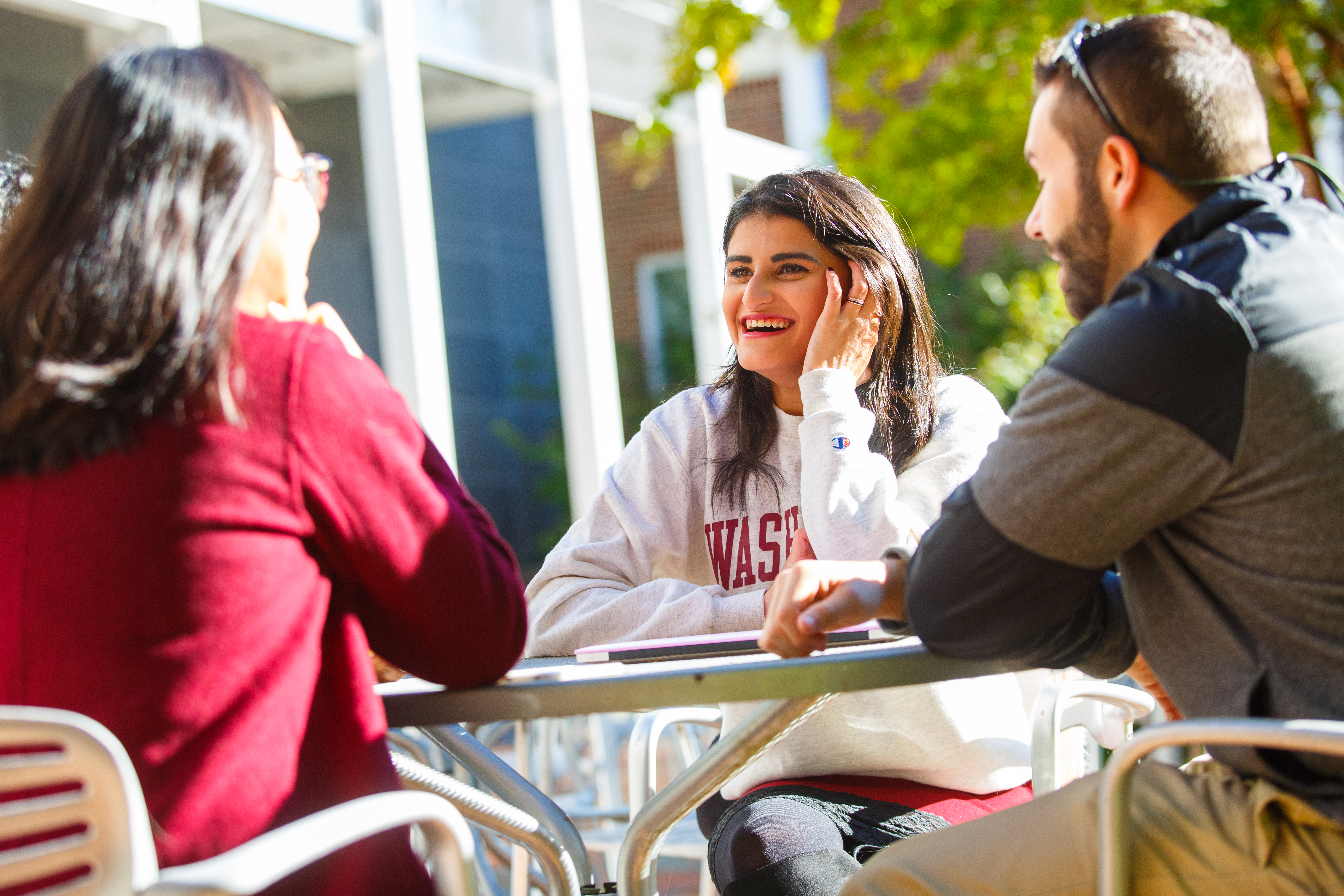 students sitting outside hodson smiling