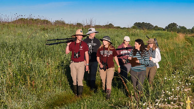 group walking in field at rafc with observation gear