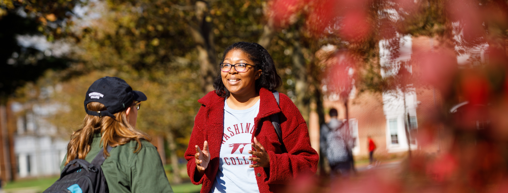 Students chatting by the baseball stadium