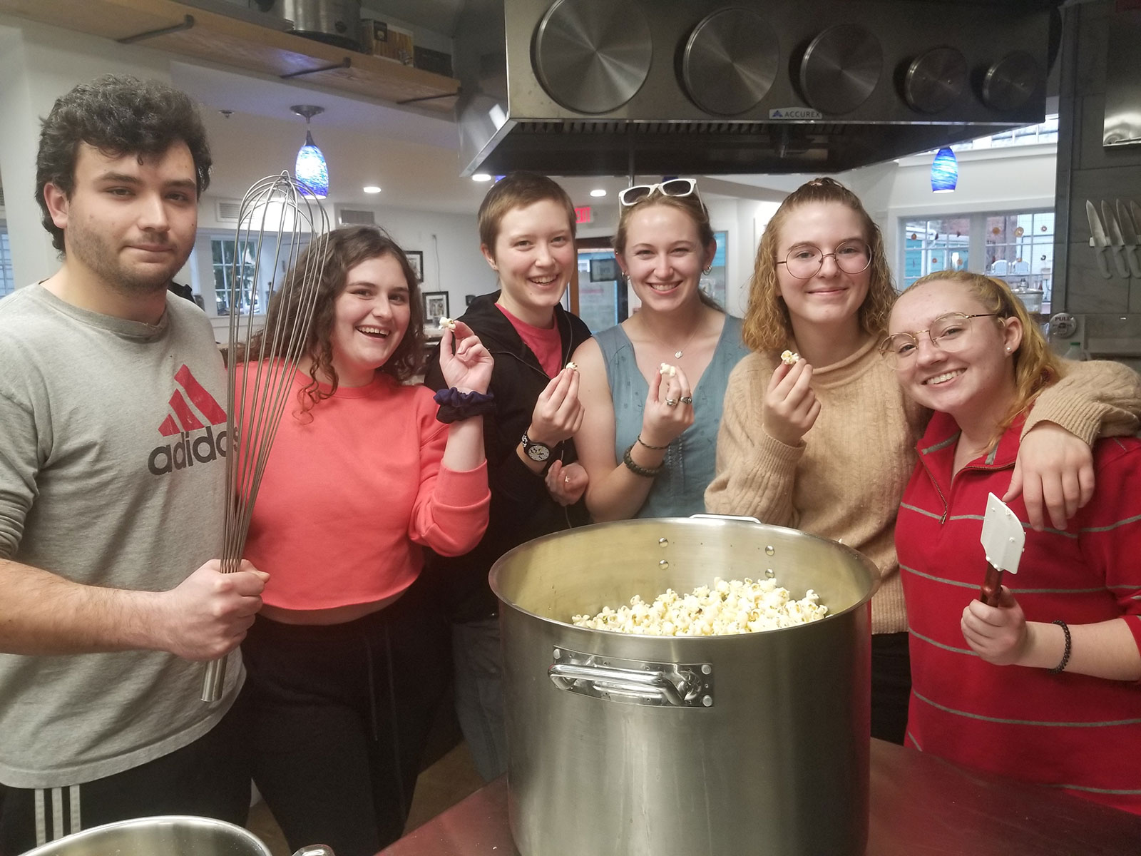 The compost team prepares a batch of popcorn for movie night