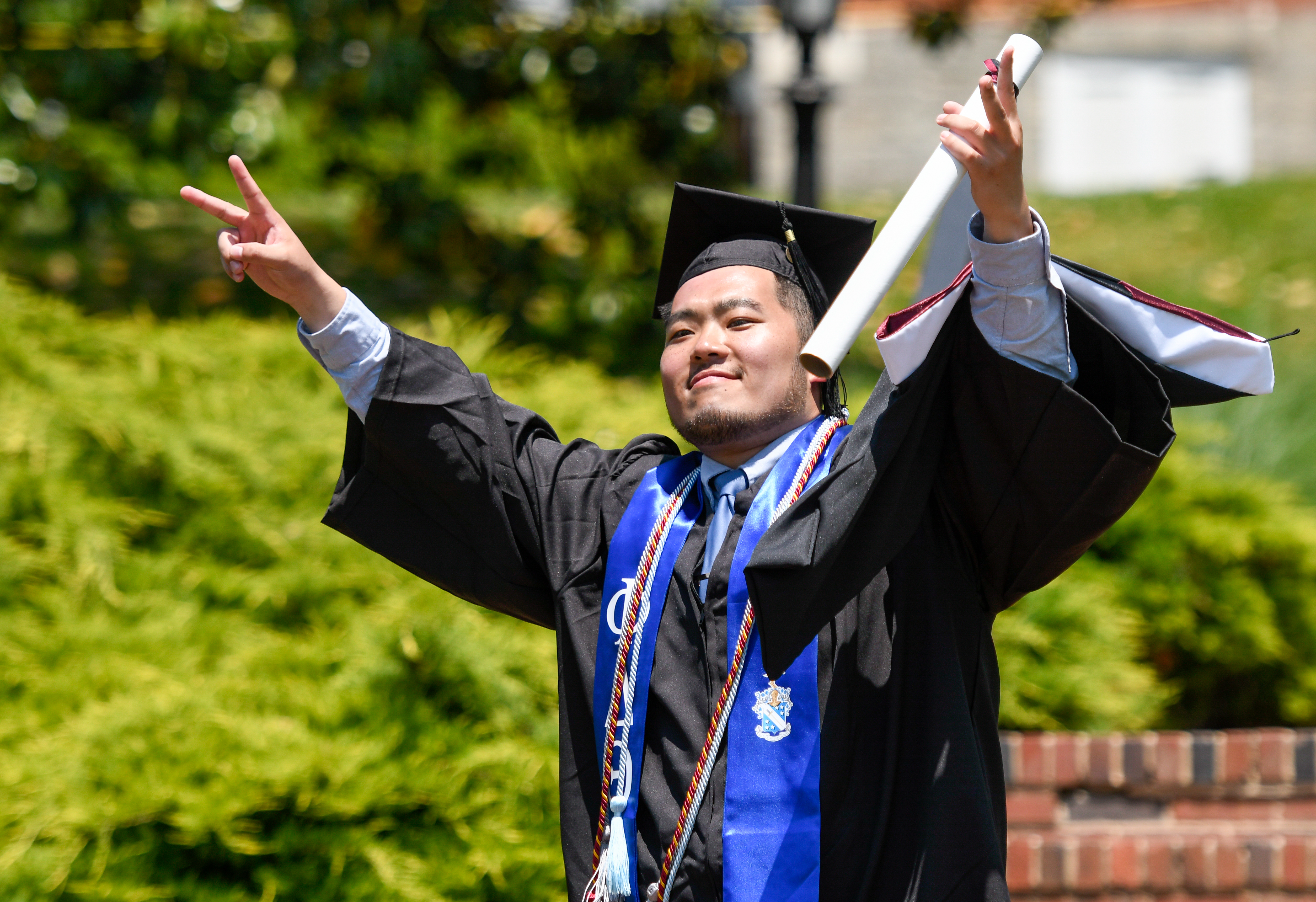 Ben Wang accepts his diploma at commencement