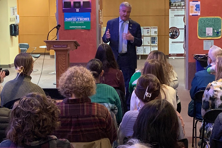 Rep. Trone speaks to an audience in the atrium of the Toll Science Center. 