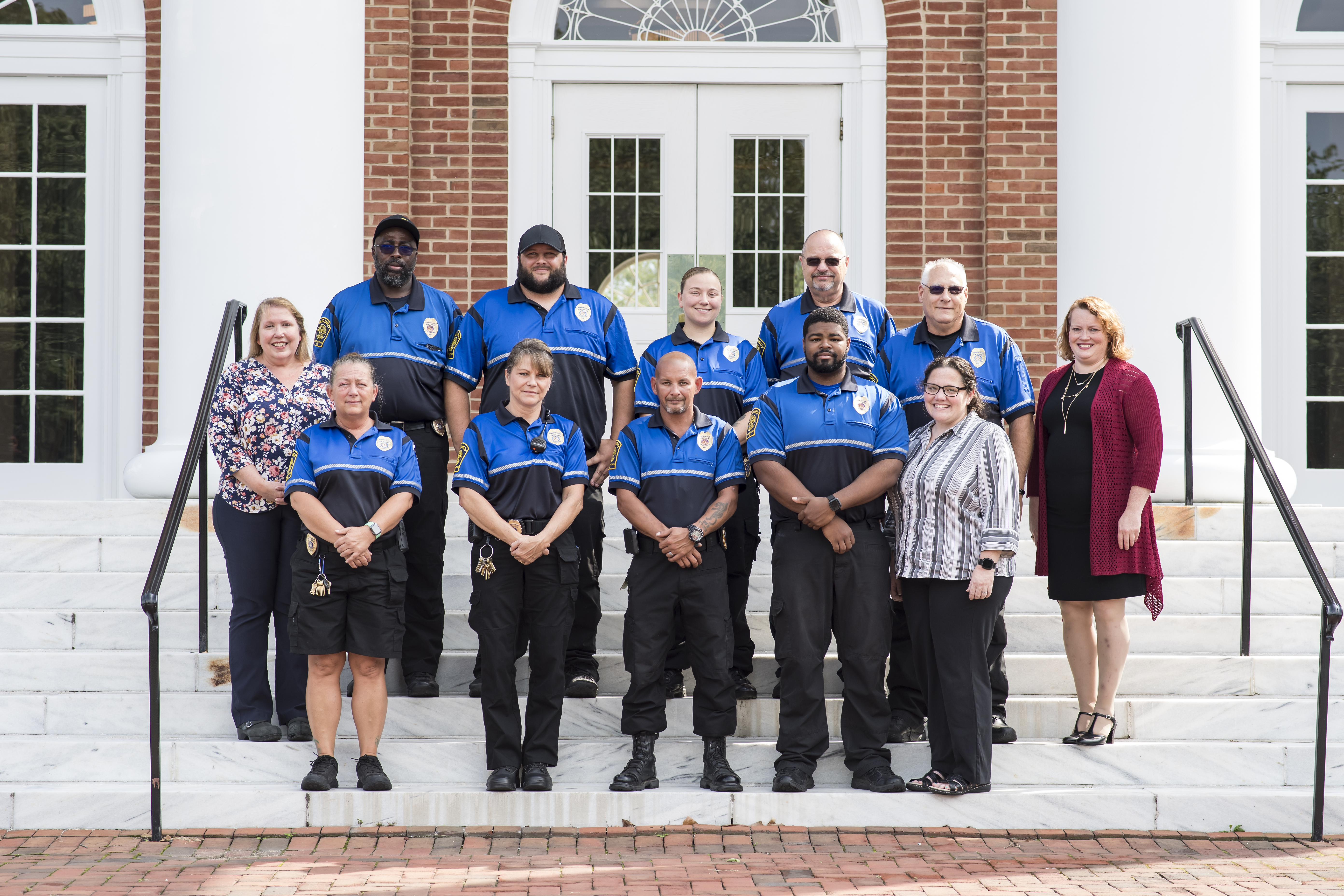 Public safety officers and staff in front of CAC building