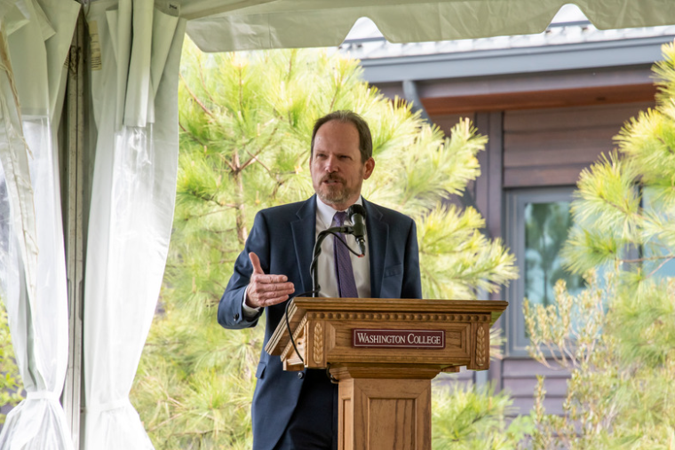 John Seidel speaking at a podium 