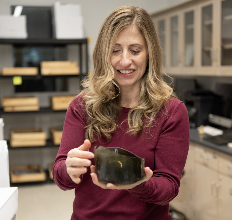 Dr. Julie Markin holds an artifact from a recent regional excavation